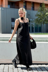 a lady in a black spaghetti strap maxi dress made of xiangyun silk